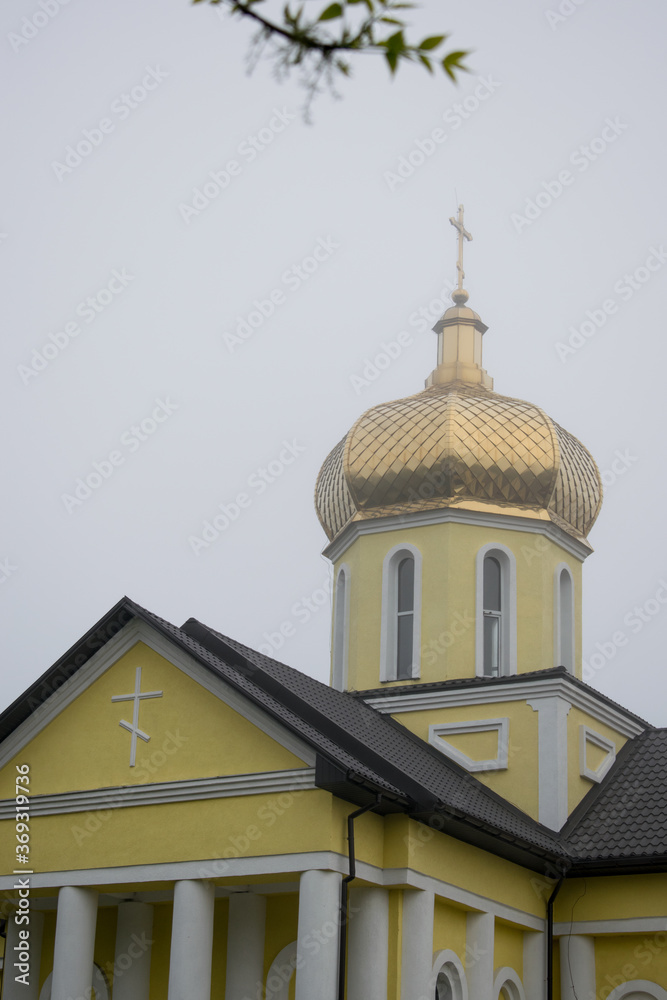 Orthodox church with golden domes on a cloudy day close-up. Religion concept