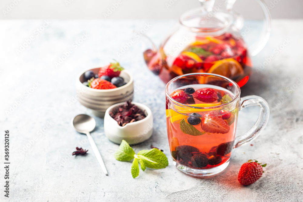 Fruit red tea with berries in glass cup on white background Fruit red tea with berries in glass cup on white background