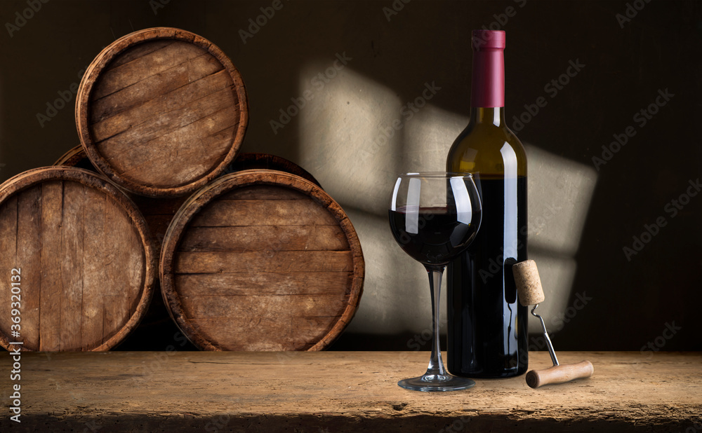 the still life with red wine, bottle, glass and old barrel