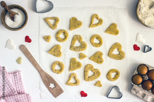 Fototapeta Naklejka Na Ścianę i Meble -  Cookies hearts molds on the dough top view. Cookies heart DIY