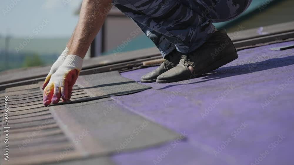 Roofing work. Laying a soft roof on the roof of a private house. Roofing work. Laying a soft roof on the roof of a private house.