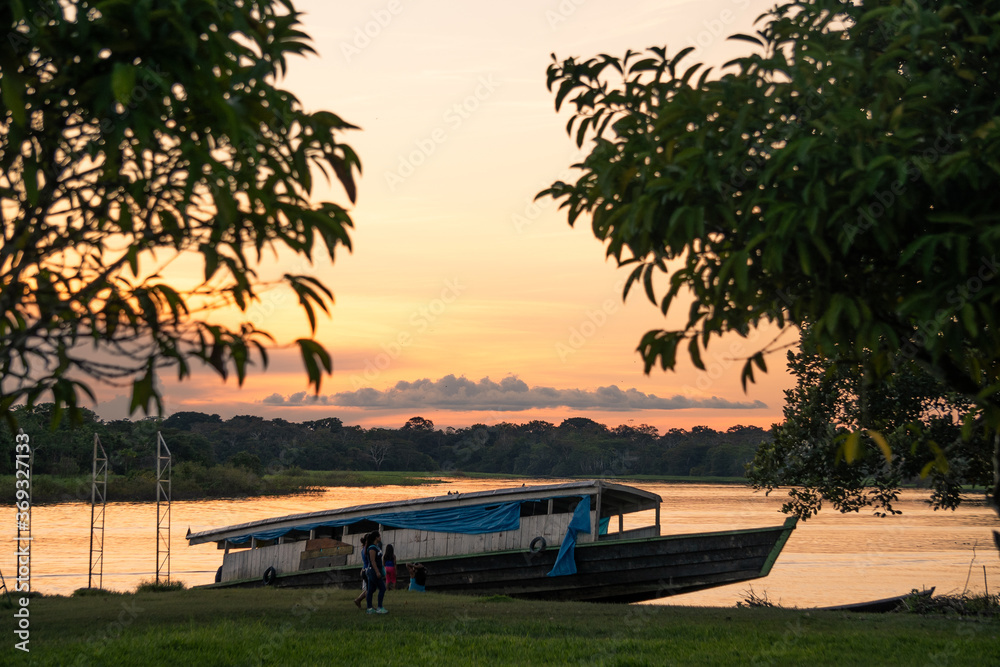 River boat on banks of Amazon river at dusk in remote city of Puerto Nariño in Colombia