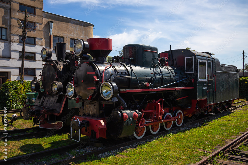 Old steam locomotives and cars on historic train station Old steam locomotives and cars on historic train station