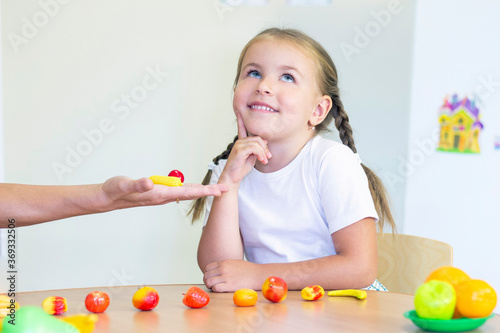 developmental and speech therapy classes with a child-girl. Speech therapy exercises and counting games. the girl thought
