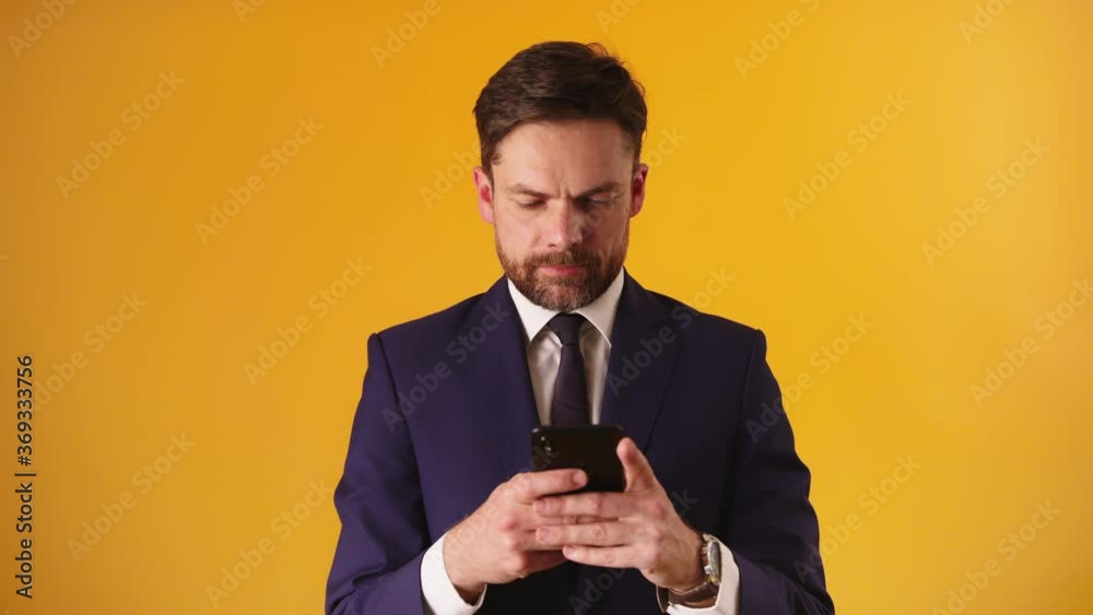 Managing business with his smartphone. Bearded caucasian businessmen sending sms. Slow motion High quality 4k footage Managing business with his smartphone. Bearded caucasian businessmen sending sms. Slow motion High quality 4k footage