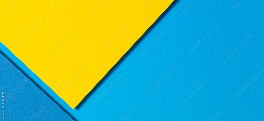 Abstract color papers geometry flat lay composition banner background with yellow and blue tones Abstract color papers geometry flat lay composition banner background with yellow and blue tones