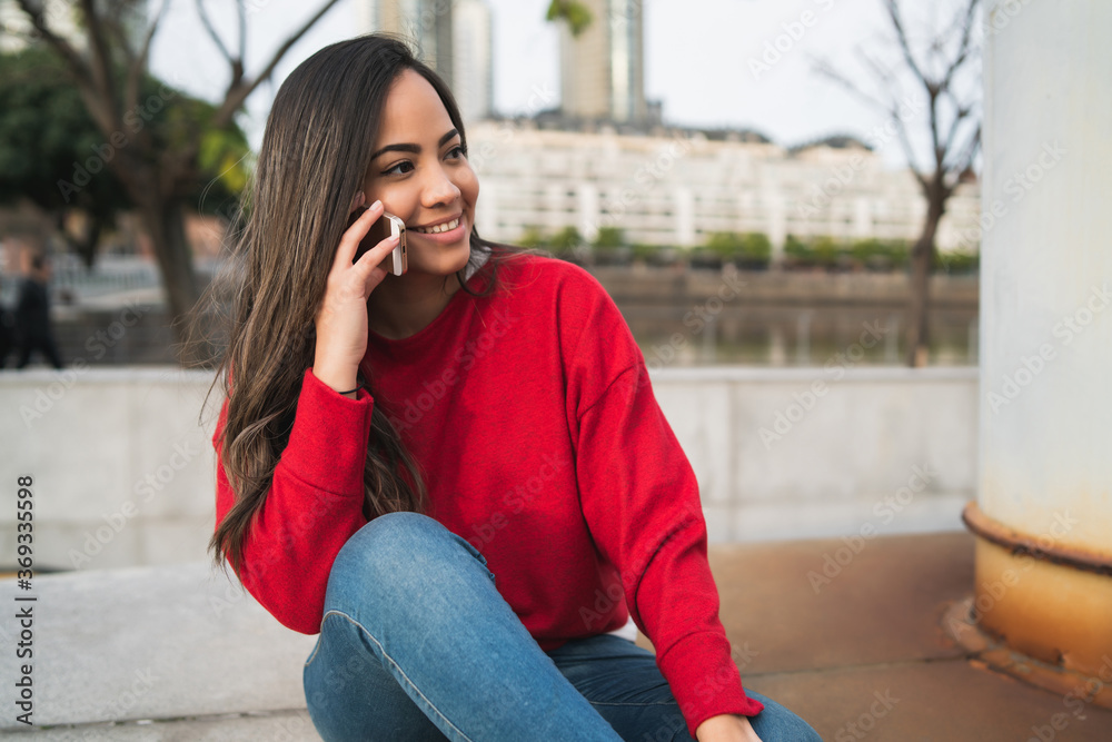 Latin woman talking on the phone. Latin woman talking on the phone.