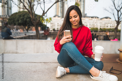 Young woman using her mobile phone. © Mego-studio