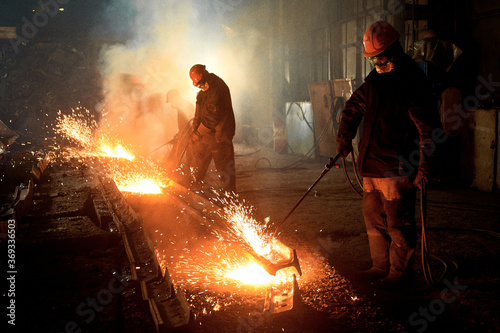 worker cuts steel
