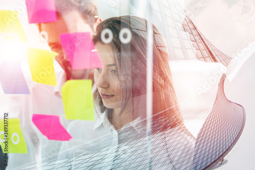 Young businesswoman working with her teammates in office. Double esposure effect photo