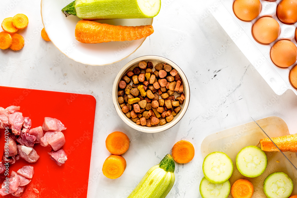 Dogfood set with vegetables, eggs and meat on table background top view Dogfood set with vegetables, eggs and meat on table background top view