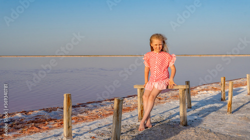 Girl poses on salt fields, pink lake, summer Crimea
