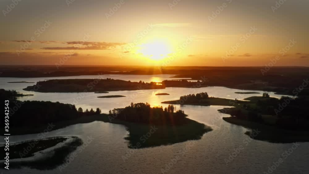 Amazing lake view from above, silhouettes of beautiful islands covered with trees and meadows in warm morning sunlight. Aerial, flight over Braslav Lakes National Park during fantastic golden sunrise Amazing lake view from above, silhouettes of beautiful islands covered with trees and meadows in warm morning sunlight. Aerial, flight over Braslav Lakes National Park during fantastic golden sunrise