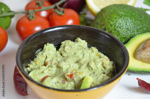 Girl make a sandwich Guacamole and bread. Toast with avocado on white background. Homemade Mexican healthy vegan food