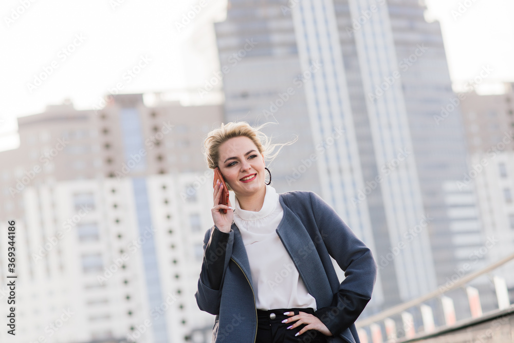 Lawyer businesswoman professional walking outdoors talking on cell smart phone drinking coffee from paper cup. Lawyer businesswoman professional walking outdoors talking on cell smart phone drinking coffee from paper cup.