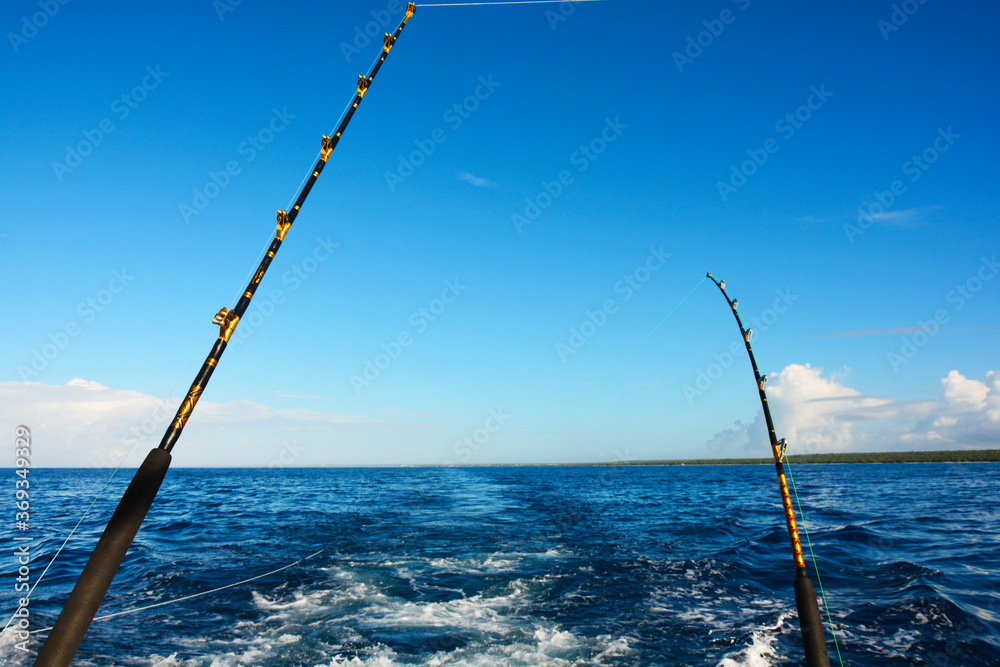Two fishing rods on a boat in the ocean