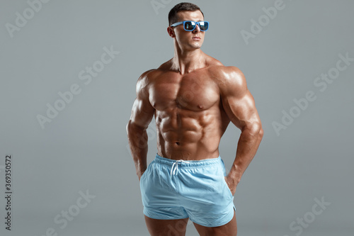 Fotografie Muscular man naked torso abs, isolated on background