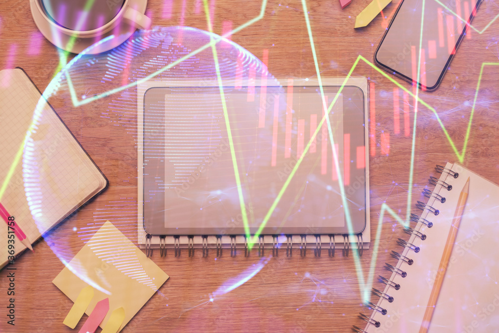 Double exposure of forex chart hologram over desktop with phone. Top view. Mobile trade platform concept. Double exposure of forex chart hologram over desktop with phone. Top view. Mobile trade platform concept.