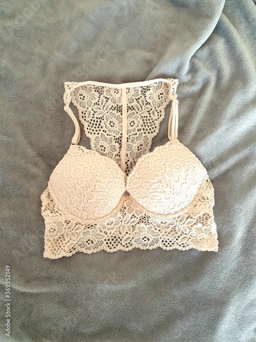 lacy beige bra on bed