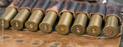 Hunting rifle with ammunition against a camouflage background