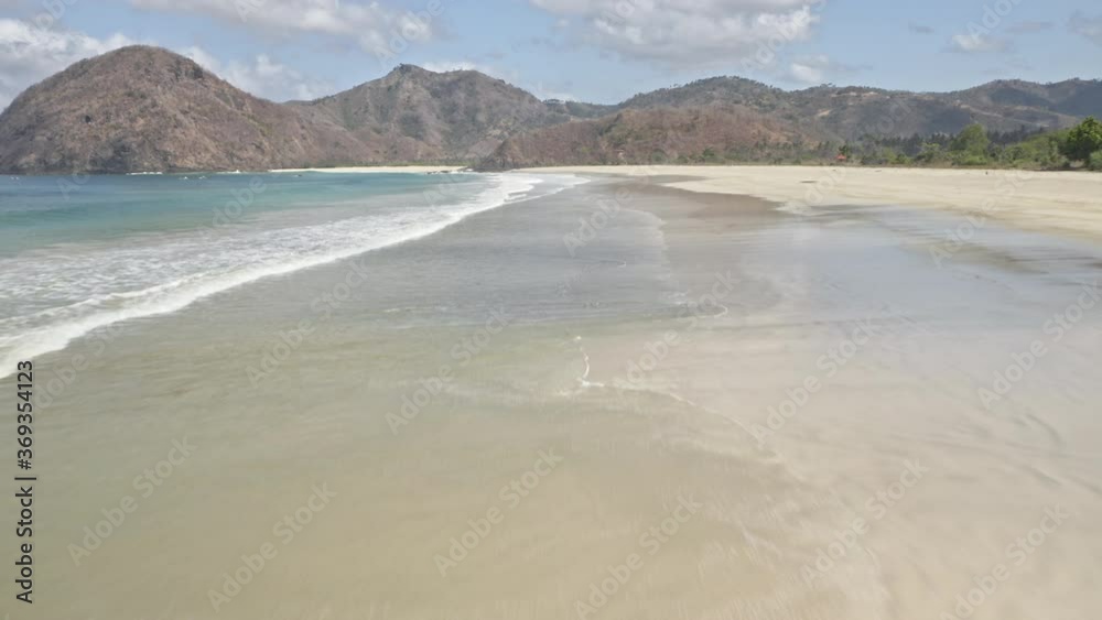Drone Hovering Above Beach Shore, Waves and Glimpse of Mountain and Sky Drone Hovering Above Beach Shore, Waves and Glimpse of Mountain and Sky