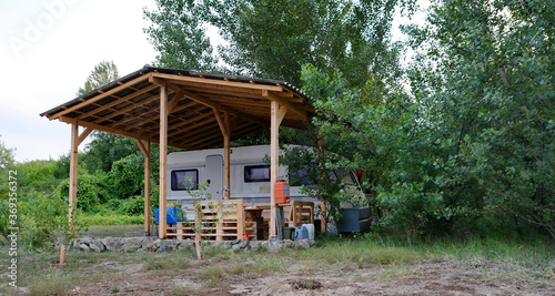 Wallpaper Mural Caravan trailer camping on a green lawn under a tree in springtime Torontodigital.ca