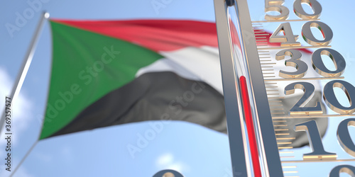 30 degrees centigrade on a thermometer measuring air temperature near flag of Sudan. Hot weather forecast related 3D rendering