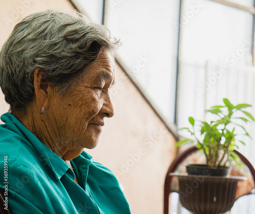 thoughtful older woman sitting on a chair