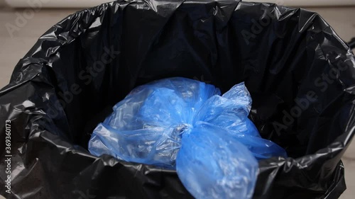 Throwing of garbage in trash bin, closeup