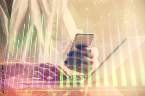 Wallpaper Mural Double exposure of financial graph sketch hologram and woman holding and using a mobile device. Stock exchange concept. Torontodigital.ca