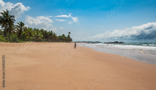 Woman moving gadgets to the other side of the beach in Axim Ghana West Africa