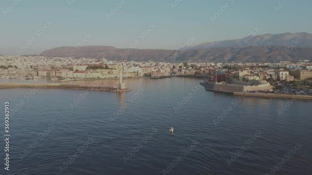 Chania Old Port lighthouse sunset aerial view drone zoom out