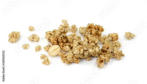 Pile of granola from above isolated on a white background. CRUNCHY hazelnut muesli isolated.