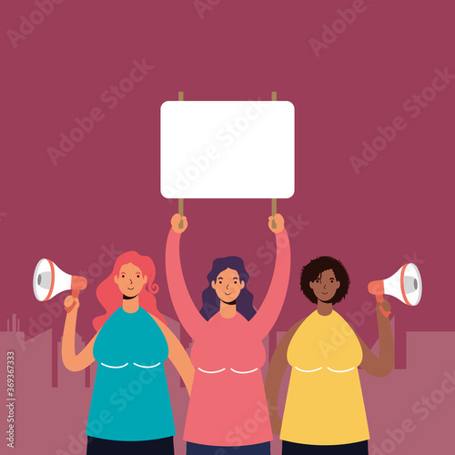 interracial women wearing medical masks protesting with placard and megaphone