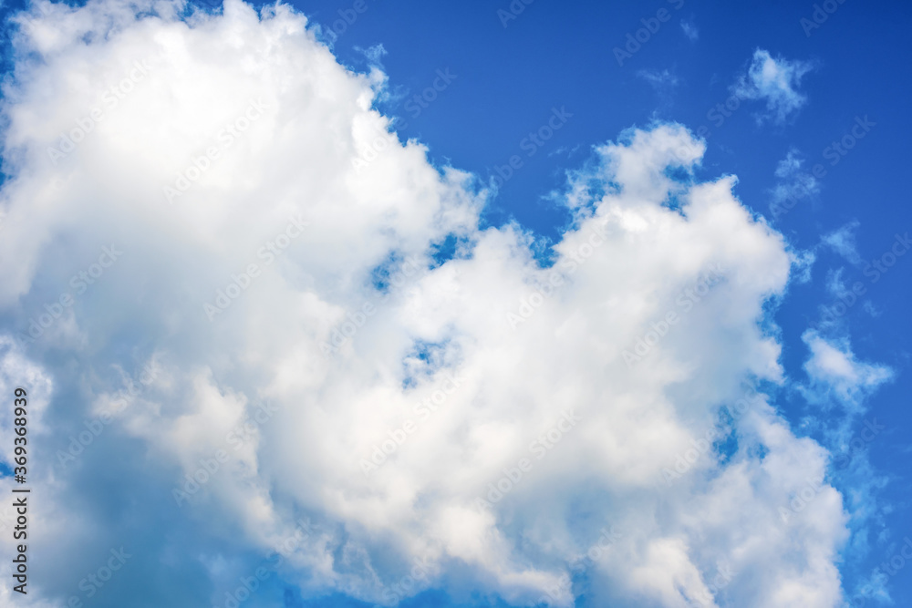 Fototapeta premium Fluffy white clouds on background of blue sky. Wallpaper.