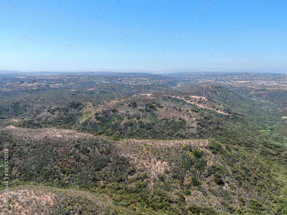 Aerial view of Los Penasquitos Canyon Preserve during summer season. Urban park with trails and river in San Diego, California. USA
