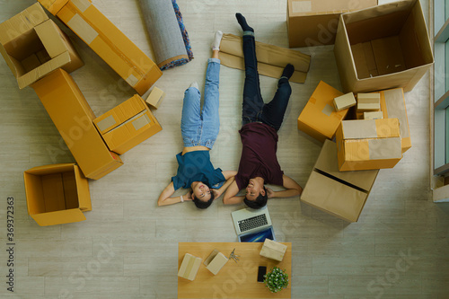 couple relax after unpacking boxes from house moving and relacation photo