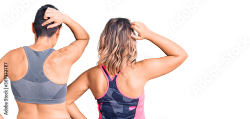 Couple of women wearing sportswear backwards thinking about doubt with hand on head