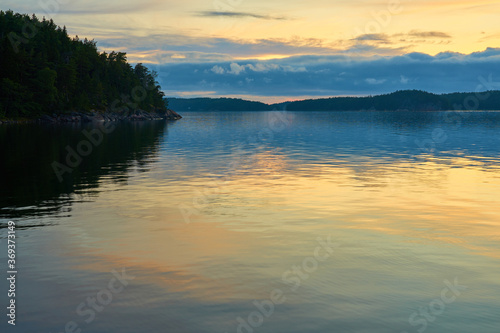 A colofrul sunset with reflections on water in an archipelago in Parainen, Finland.