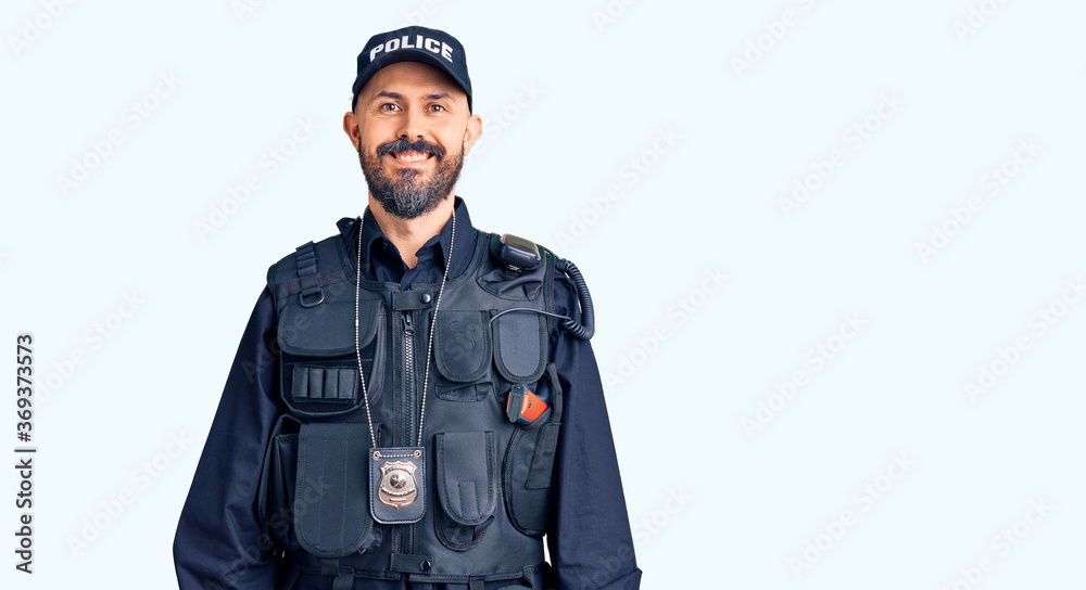 Young handsome man wearing police uniform with a happy and cool smile on face. lucky person. Young handsome man wearing police uniform with a happy and cool smile on face. lucky person.