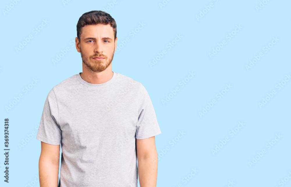 Handsome young man with bear wearing casual tshirt depressed and worry for distress, crying angry and afraid. sad expression. Handsome young man with bear wearing casual tshirt depressed and worry for distress, crying angry and afraid. sad expression.