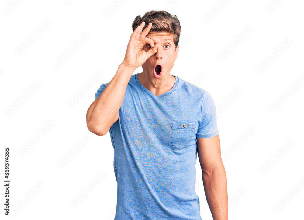 Young handsome man wearing casual clothes doing ok gesture shocked with surprised face, eye looking through fingers. unbelieving expression. Young handsome man wearing casual clothes doing ok gesture shocked with surprised face, eye looking through fingers. unbelieving expression.