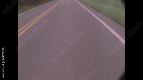 POV of driving down center line of road / shot on Super 8 film