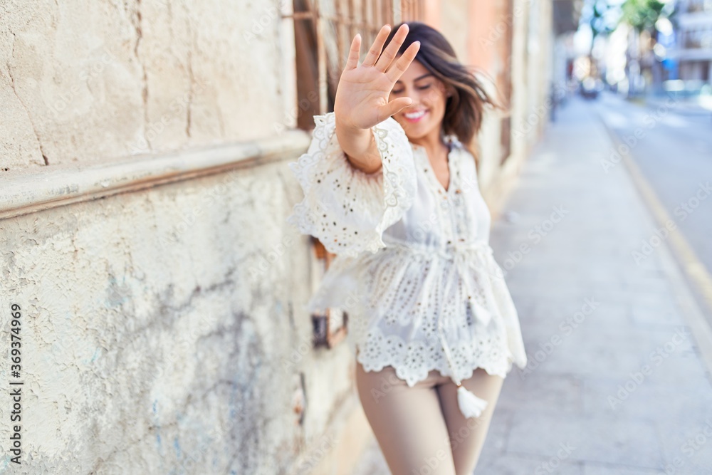 Beautiful young woman wearing fashionable clothes walking down the street Beautiful young woman wearing fashionable clothes walking down the street