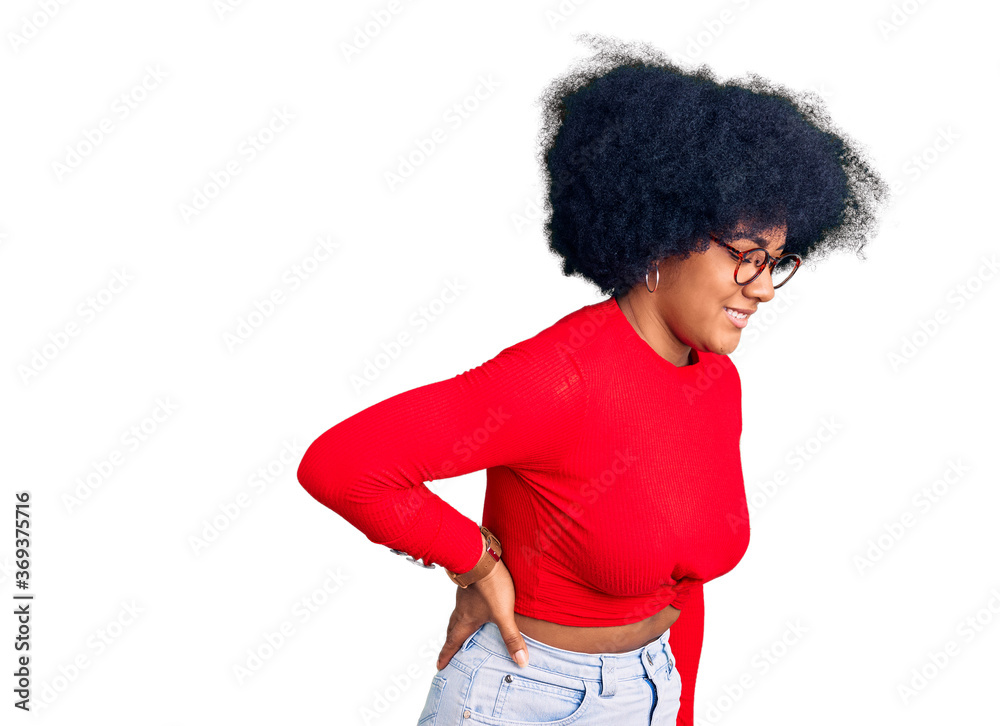 Young african american girl wearing casual clothes and glasses suffering of backache, touching back with hand, muscular pain Young african american girl wearing casual clothes and glasses suffering of backache, touching back with hand, muscular pain