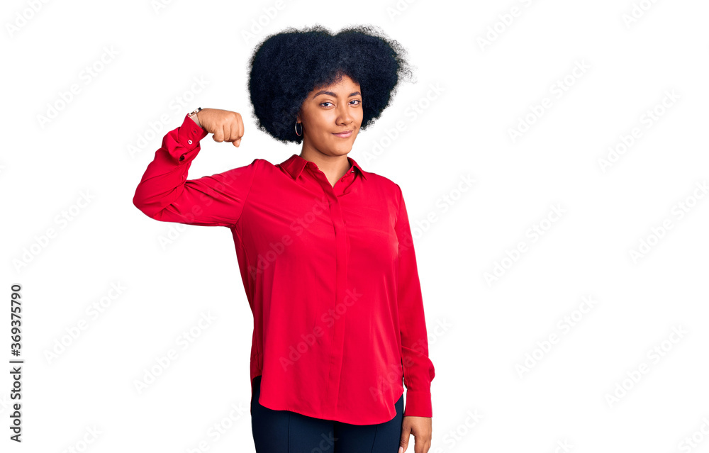 Young african american girl wearing casual clothes strong person showing arm muscle, confident and proud of power Young african american girl wearing casual clothes strong person showing arm muscle, confident and proud of power
