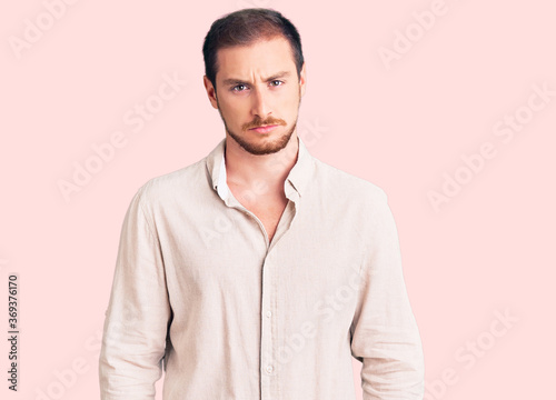 Young handsome caucasian man wearing casual clothes skeptic and nervous, frowning upset because of problem. negative person. © Krakenimages.com