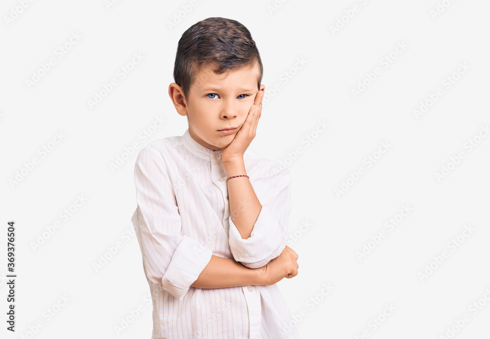Cute blond kid wearing elegant shirt thinking looking tired and bored with depression problems with crossed arms.