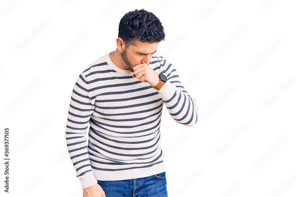 Young hispanic man wearing casual clothes feeling unwell and coughing as symptom for cold or bronchitis. health care concept. Young hispanic man wearing casual clothes feeling unwell and coughing as symptom for cold or bronchitis. health care concept.