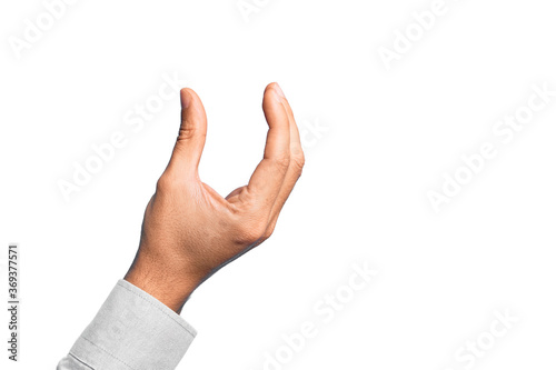 Hand of caucasian young man showing fingers over isolated white background picking and taking invisible thing, holding object with fingers showing space